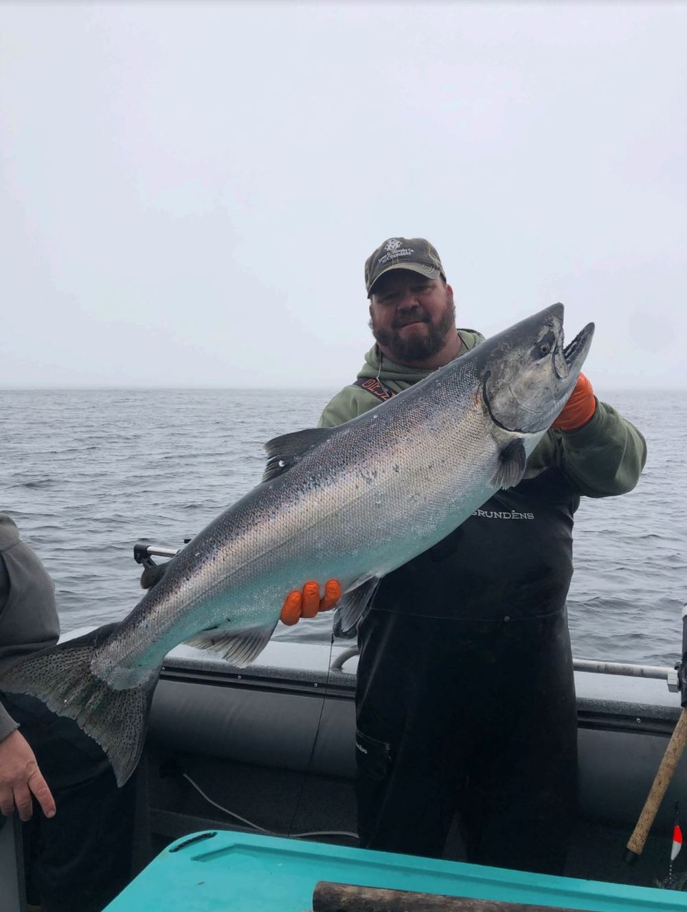 Angler holding a large king salmon caught on a guided trip out of Eagle Rock Lodge